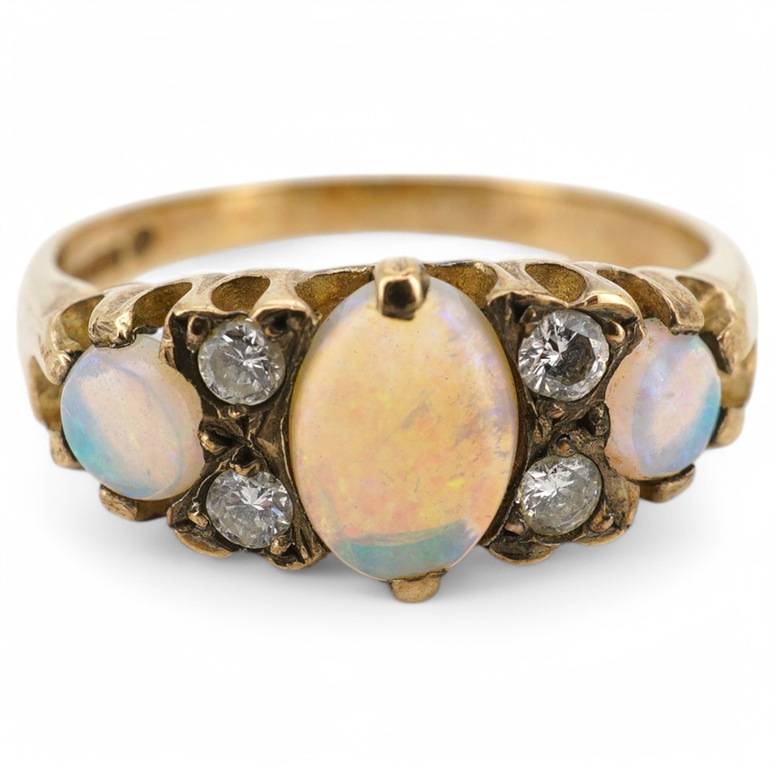 A modern 9ct gold, three stone white opal and four stone diamond set half hoop ring, size N, gross weight 2.4 grams.